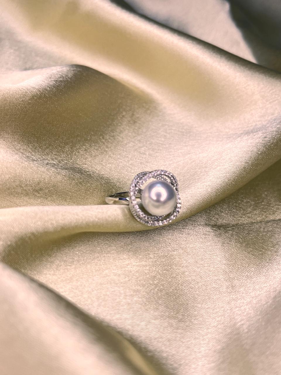 Pearl ring on a satin surface