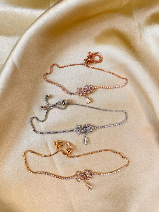 Set of gold and silver necklaces on a beige fabric background